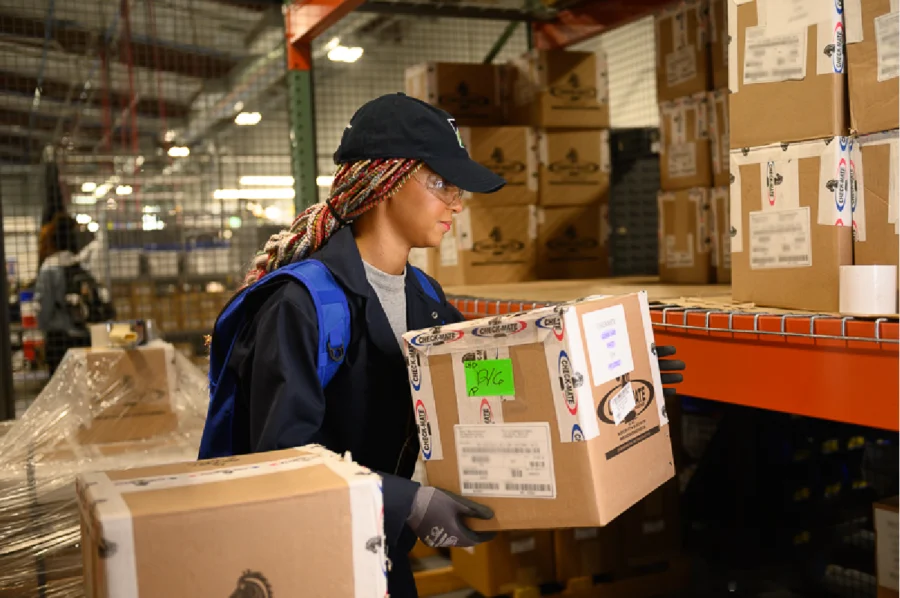 woman stocking boxes in warehouse