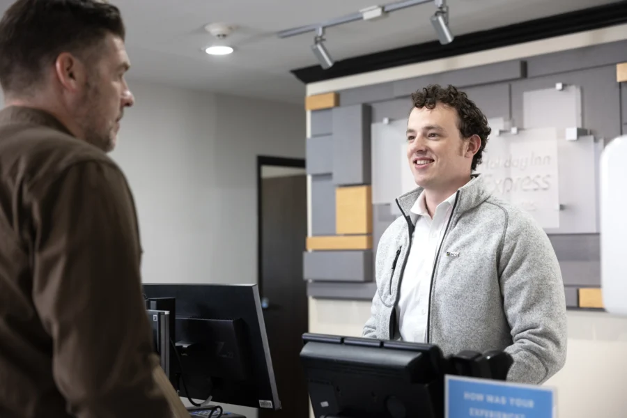 Hotel concierge smiling at guest.