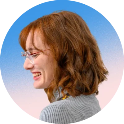Headshot of young woman smiling with a gradient background.